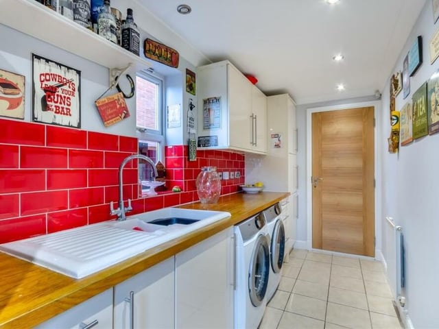 Just off the kitchen is this bright utility room, complete with free-standing fridge/freezer that is available to buy by separate negotiation. There is plumbing for a washing machine and space for a tumble dryer, as well as cupboards, units and drawers, sink, spotlights and a door that leads out the garden.