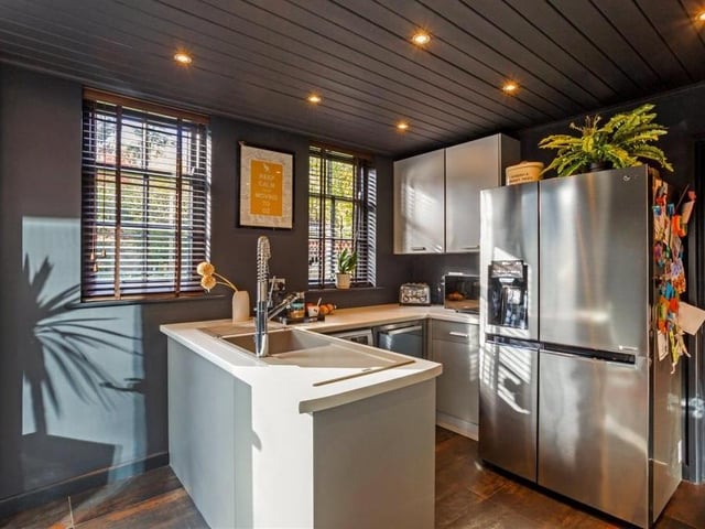 Just off the kitchen is this extraordinarily well-fitted utility room, with composite sink and drainer. It has useful storage units, a washing machine and a wine fridge, plus space for a double fridge/freezer. Doors lead to the double garage.