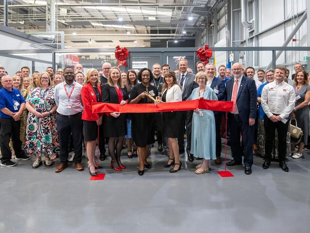 Special guests and college leaders celebrate the unveiling.