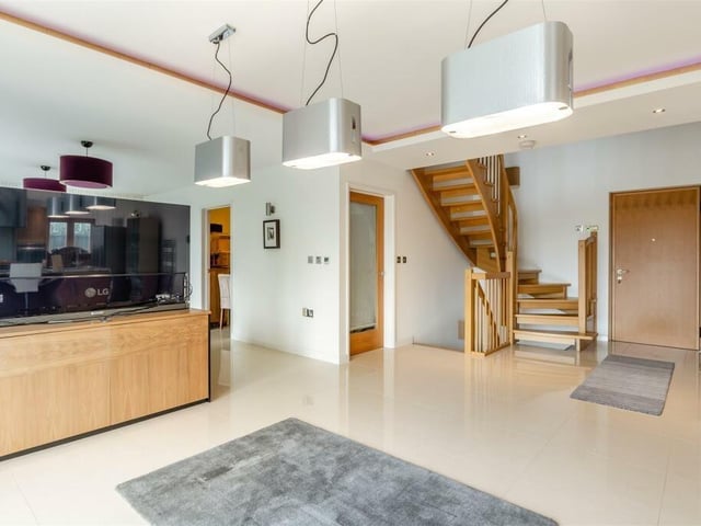 On stepping through the front door at The Glass House, you are greeted by an open-plan entrance hall with a vaulted ceiling exposing the galleried landing on the first floor. You are also struck by the porcelain tiled floor, three ceiling spotlights and a solid oak staircase leading not only to the first floor but also to the lower ground floor.