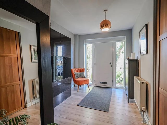 Upon entering, you are greeted by a spacious entrance hall that leads to a separate inner hallway, enhancing the flow of the home.
