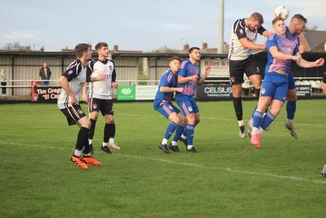 Charlie Taylor challenges for a header