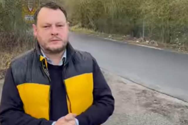 Coun Jason Zadrozny-Bland next to a newly resurfaced section of Mill Lane