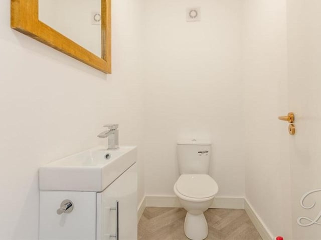 No-one turns their noses up at a downstairs toilet. This one at the Jenny Beckett's Lane property is fitted with a low-flush WC, wash hand basin with vanity unit, herringbone-style flooring and extractor fan.