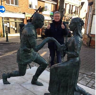 Councillor John Peck gives a thumbs up to Edwinstowe’s restored Robin Hood statue.