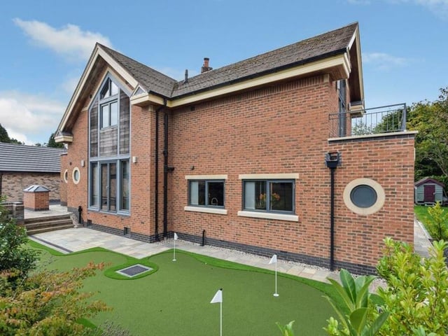 And here's what you've been waiting for -- that golf course, or rather putting green, within the front garden of the unique Ravenshead house.
