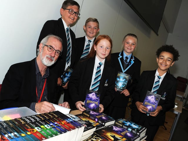 Author Joseph Delaney, chats with book fans, Fynley Cameron, Mitchell Timmons, Maimee Oates, Lillie Rose and Lamin Sanno during his visit to the Shirebrook Academy in 2019.
