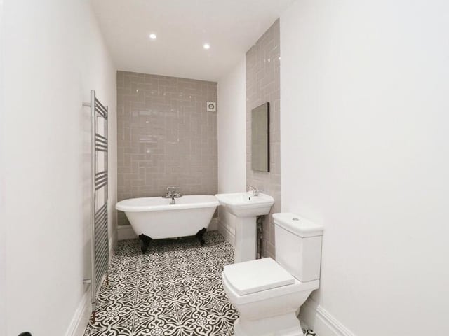 The family bathroom is a strikingly simple space. It comprises a free-standing, claw-foot bath, a pedestal wash basin, WC and heated towel-rail.