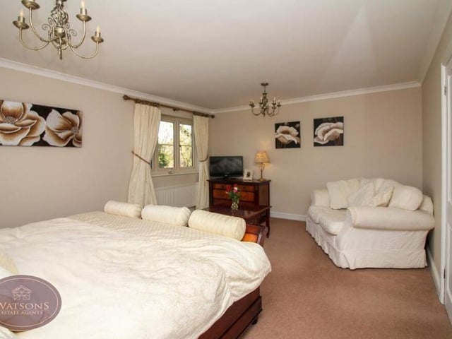 The primary bedroom from a different angle, underlining its depth and comfort.