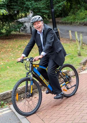 Paddy Tipping tests out an electric bike.