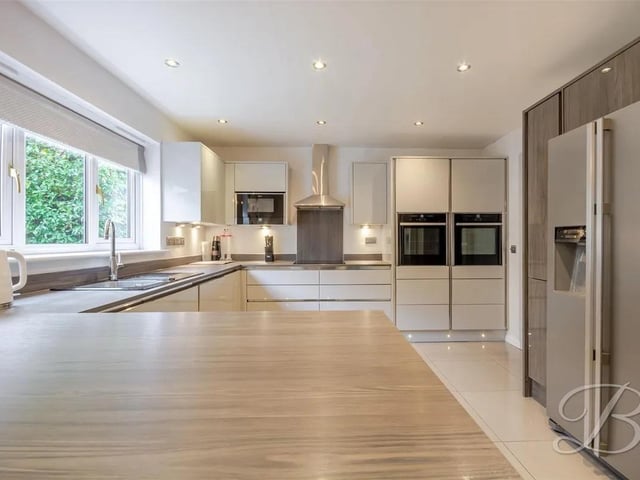 The kitchen features a number of integrated appliances including ovens, microwave, electric hob, and extractor.