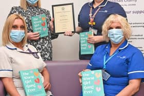 Sian Robinson (back left) donating books to the EPU at King's Mill Hospital last year. Photo: Submitted