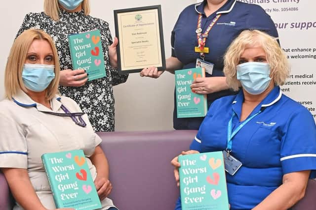 Sian Robinson (back left) donating books to the EPU at King's Mill Hospital last year. Photo: Submitted