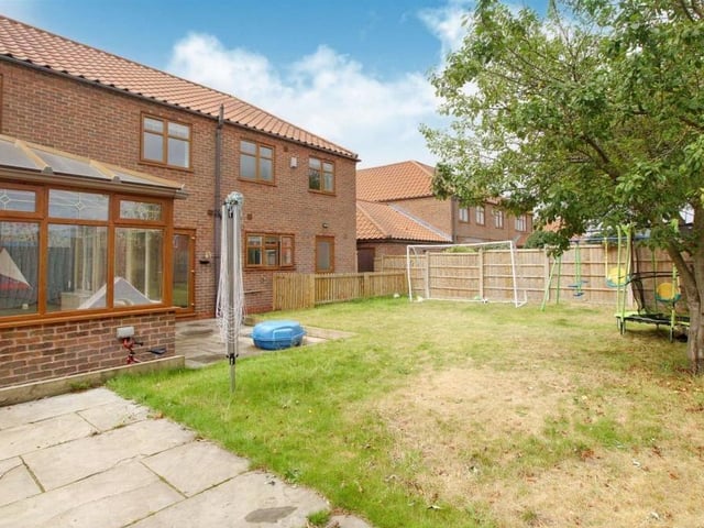A view from the back of the Forest Town property shows how the garden is ideal for play or for relaxing in the shadow of the tree.