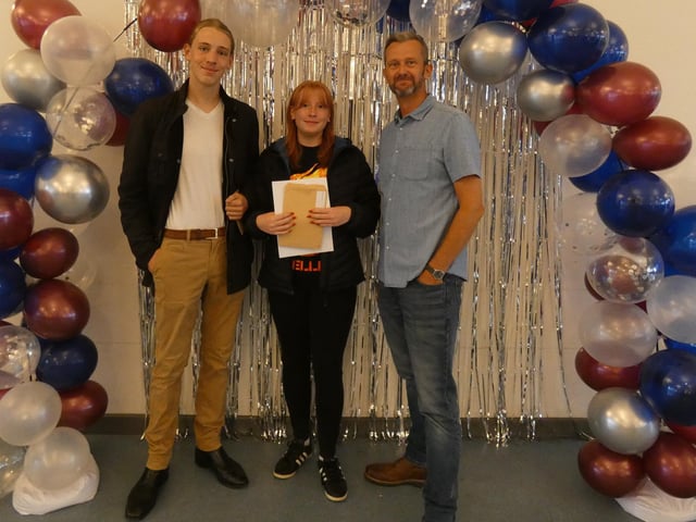 Will Jacques and Tehya Vernon with Chris Woollard, headteacher