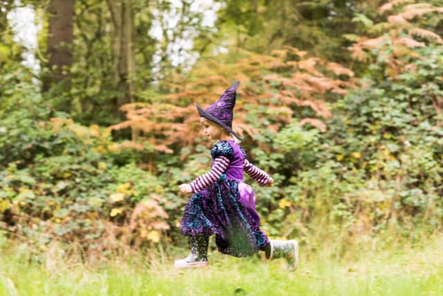 Girl dressed as a witch enjoying the special Halloween trail