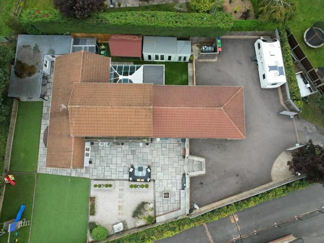 The full footprint of the Mansfield Road plot can be seen from this drone shot, which gives a bird's eye view. You can also see the extensive driveway, which provides off-street parking space for multiple vehicles.