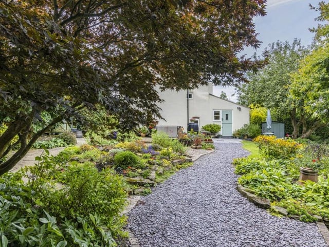 The pathway that leads to the cottage entrance. There is also a good-sized driveway that provides ample space for off-street parking.