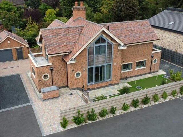 This drone shot gives a bird's eye view of the front of the majestic £749,500 property on Kighill Lane in desirable Ravenshead. Individually designed, it is quite a sight, with all its special features.