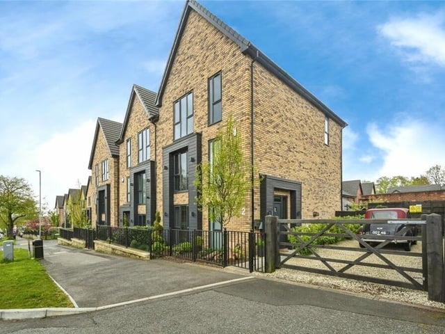 Let's step outside now, and this shot underlines the striking external design of the £400,000 house. There is gated access to an extra piece of gravelled land to the side which is perfect for off-street parking.
