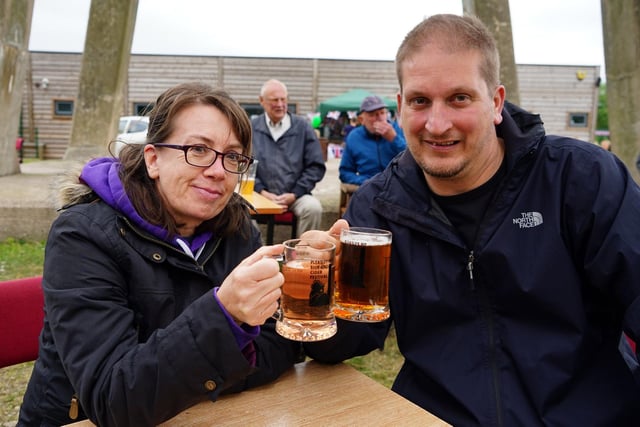 Michelle and Gavin clink glasses at the Pleasley beer festival.