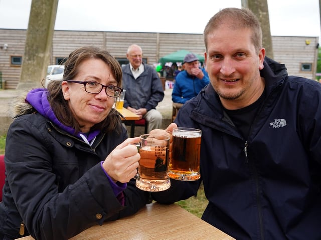 Michelle and Gavin clink glasses at the Pleasley beer festival.