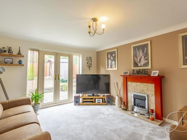 The main reception room in the house is this delightful lounge, which offers an abundance of space in which to add your personal stamp. The highlights are a feature fireplace and French doors that lead out to the back garden. The floor is carpeted.