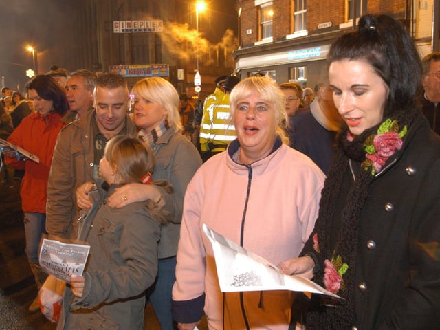 Visitors to the Kirkby Christmas Carnival in 2006 joining in the carol singing