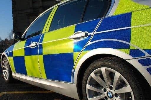 Police investigating a shop theft in Sutton where a staff member was assaulted have charged a suspect.