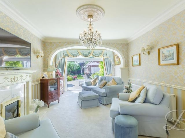 The ground floor of the Kirkby property is dominated by this beautiful open-plan lounge that creates a warm and welcoming atmosphere. It includes a traditional feature fireplace, a carpeted floor and sliding doors leading out to the garden.