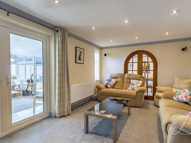 A last look at the bright and bonny living room, with its carpeted floor and downlights.