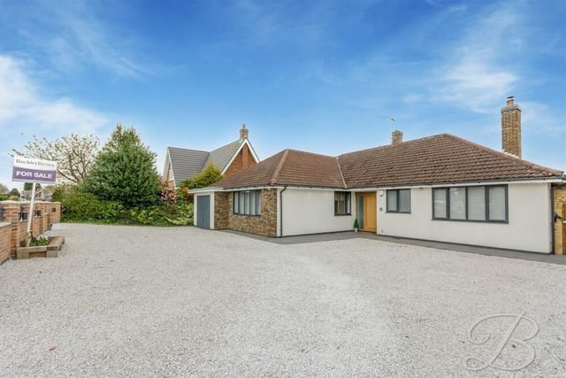 We close our gallery by returning to the front of the £535,000-plus bungalow, where a gravelled driveway offers ample off-street parking space for several vehicles and leads to an integral garage.