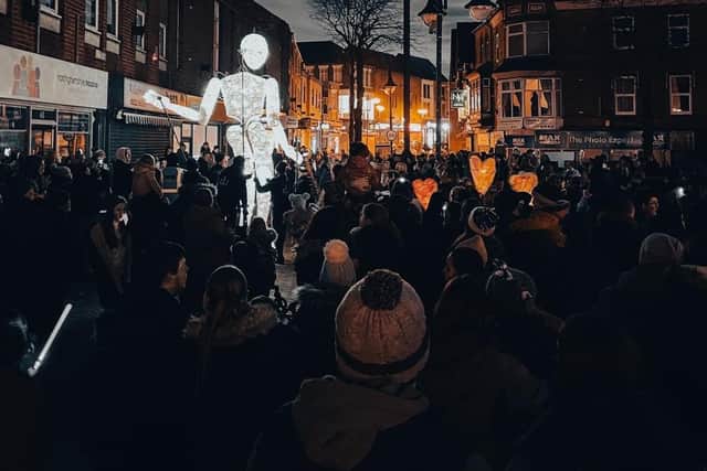 A giant illuminated puppet attracts the crowds in Sutton.