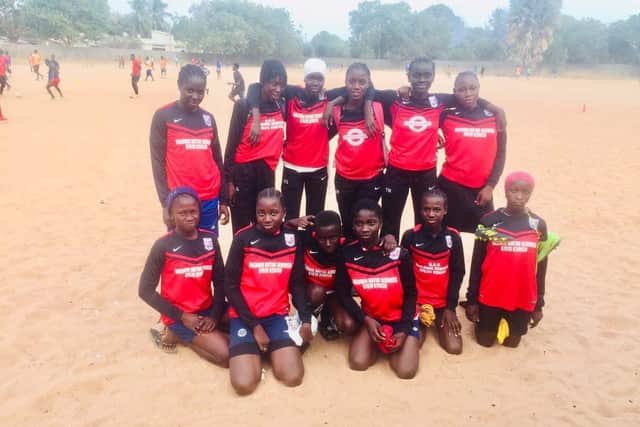 Children in Gambia wearing kits donated by Teversal FC.