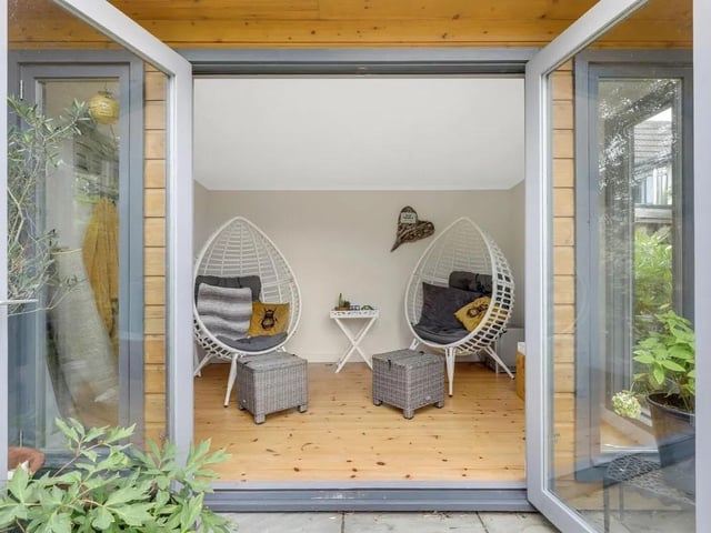 The garden room provides a versatile and naturally bright additional living space with electrics, featuring attractive wood flooring and UPVC double-glazed windows overlooking the rear garden. French doors open directly onto the garden, creating a seamless connection between the indoor and outdoor spaces and making the room ideal for relaxing, entertaining or use as a home office.