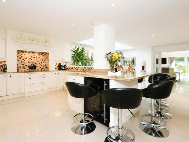 As you can see, there is plenty of room for a breakfast table/island in the kitchen. The space also features an integrated oven, hob, extractor fan, microwave, dishwasher, fridge and wine cooler.