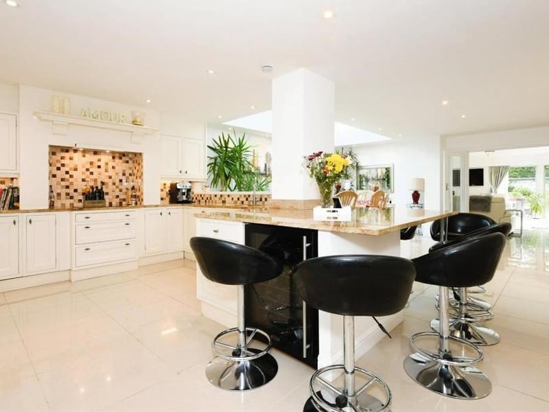 As you can see, there is plenty of room for a breakfast table/island in the kitchen. The space also features an integrated oven, hob, extractor fan, microwave, dishwasher, fridge and wine cooler.