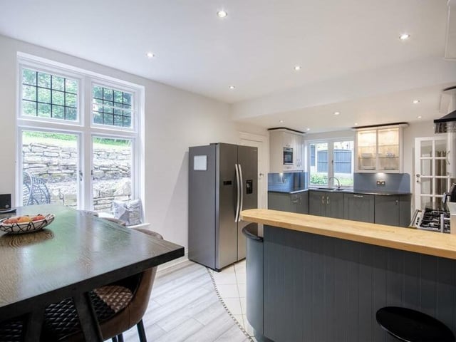 The kitchen also has space for a dining area and a large fridge/freezer.