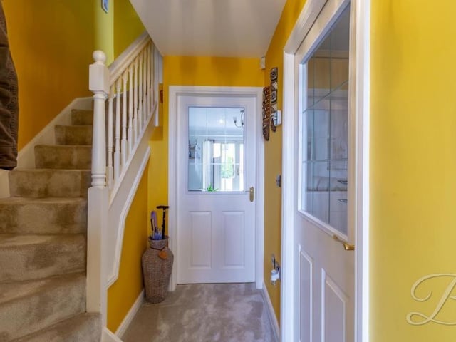Time to seek out the first floor now, via this staircase in the entrance hallway. The door at the far end leads into the lounge.