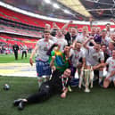 LONDON, ENGLAND - MAY 28: Players and staff of Port Vale celebrate with the Sky Bet League Two Play Off Trophy following their sides victory in the Sky Bet League Two Play-off Final match between Mansfield Town and Port Vale at Wembley Stadium on May 28, 2022 in London, England. (Photo by Eddie Keogh/Getty Images)