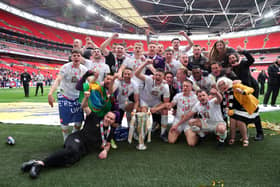 LONDON, ENGLAND - MAY 28: Players and staff of Port Vale celebrate with the Sky Bet League Two Play Off Trophy following their sides victory in the Sky Bet League Two Play-off Final match between Mansfield Town and Port Vale at Wembley Stadium on May 28, 2022 in London, England. (Photo by Eddie Keogh/Getty Images)