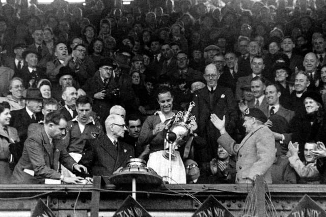 Pompey captain Reg Flewin with the championship trophy at Fratton Park at the end of the 1948-49 season, alongside club president Field Marshal Montgomery