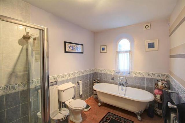 This family-sized bathroom can be accessed on the ground floor via the hallway or master bedroom. It comes with a shower cubicle, a free-standing bathtub, WC and sink unit.