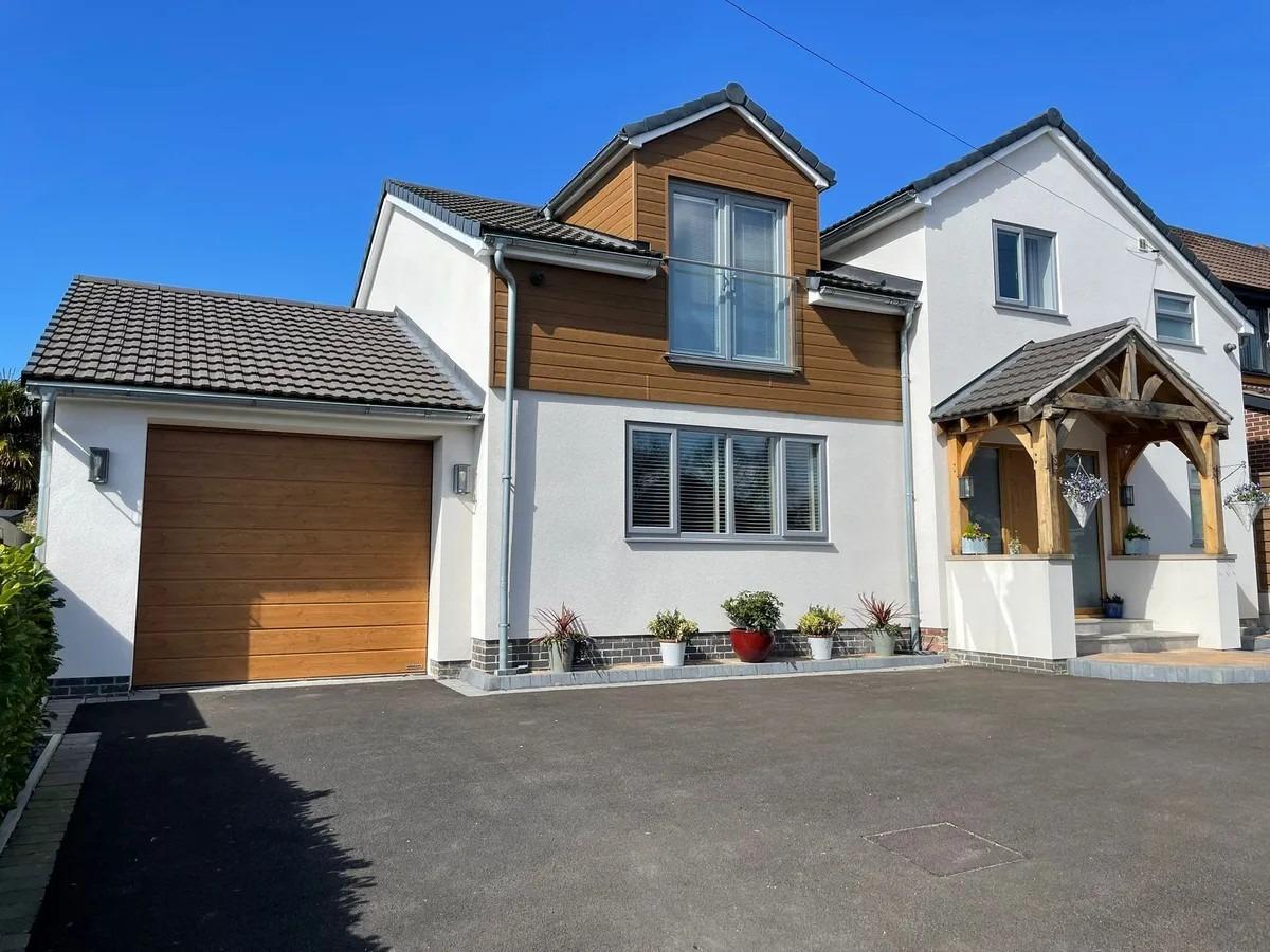 Outside, the property offers a double driveway and a tandem garage with an electric roller door, power, and lighting.