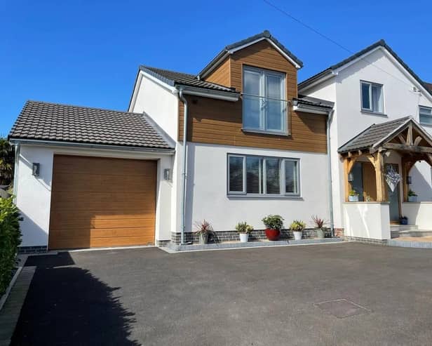 Outside, the property offers a double driveway and a tandem garage with an electric roller door, power, and lighting.