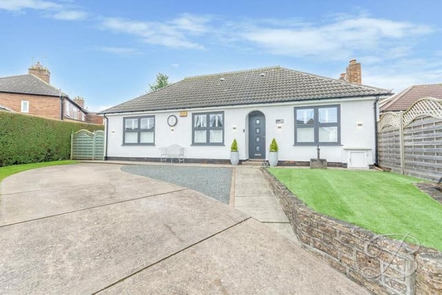 Returning to the front of the £375,000-plus Kirkby bungalow, where a lengthy driveway provides ample off-street parking space.