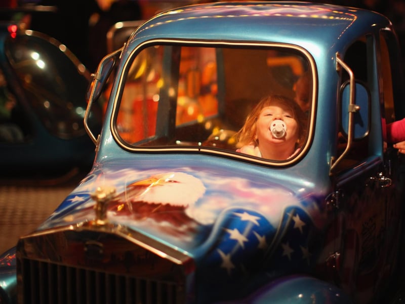 A young girl enjoys a childrens ride at the fair ground at the fair in 2010.