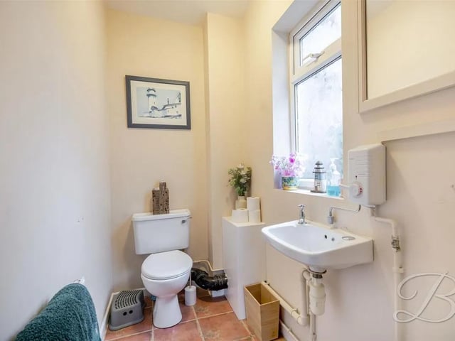A convenient two-piece suite with a low flush toilet, hand wash basin and elegantly finished, tiled flooring.
