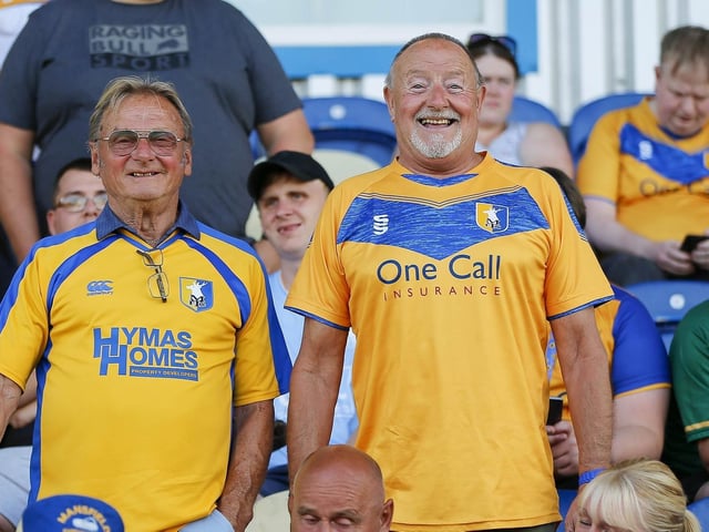 Mansfield fans watch the Carabao Cup first round match against Derby County FC at the One Call Stadium.