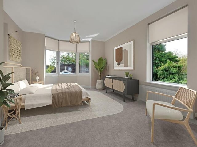 We complete our tour of the first floor with a peek at the substantial but stylish third double bedroom. It features windows to the side and back of the house, plus a fitted wardrobe with shelving.